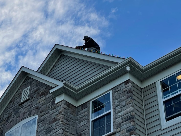 Daytime install – technician working safely on ridge