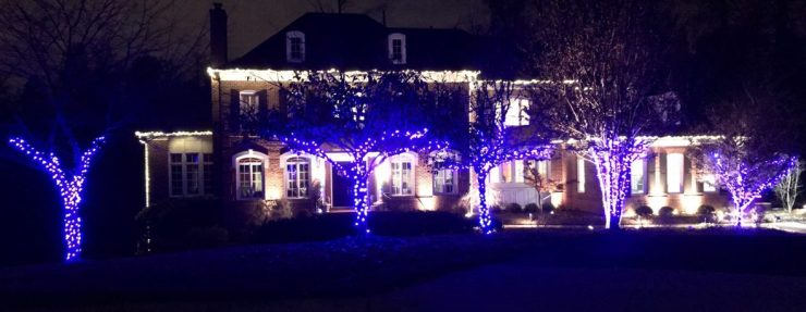 Blue tree wraps with warm roofline on large brick home
